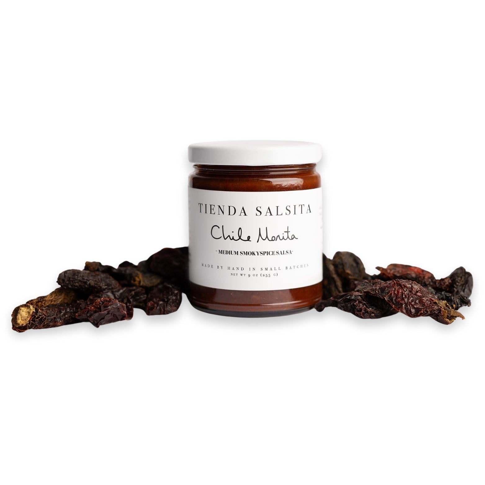 Jar of Tienda Salsita Chile Morita sauce with dried chiles on a white background