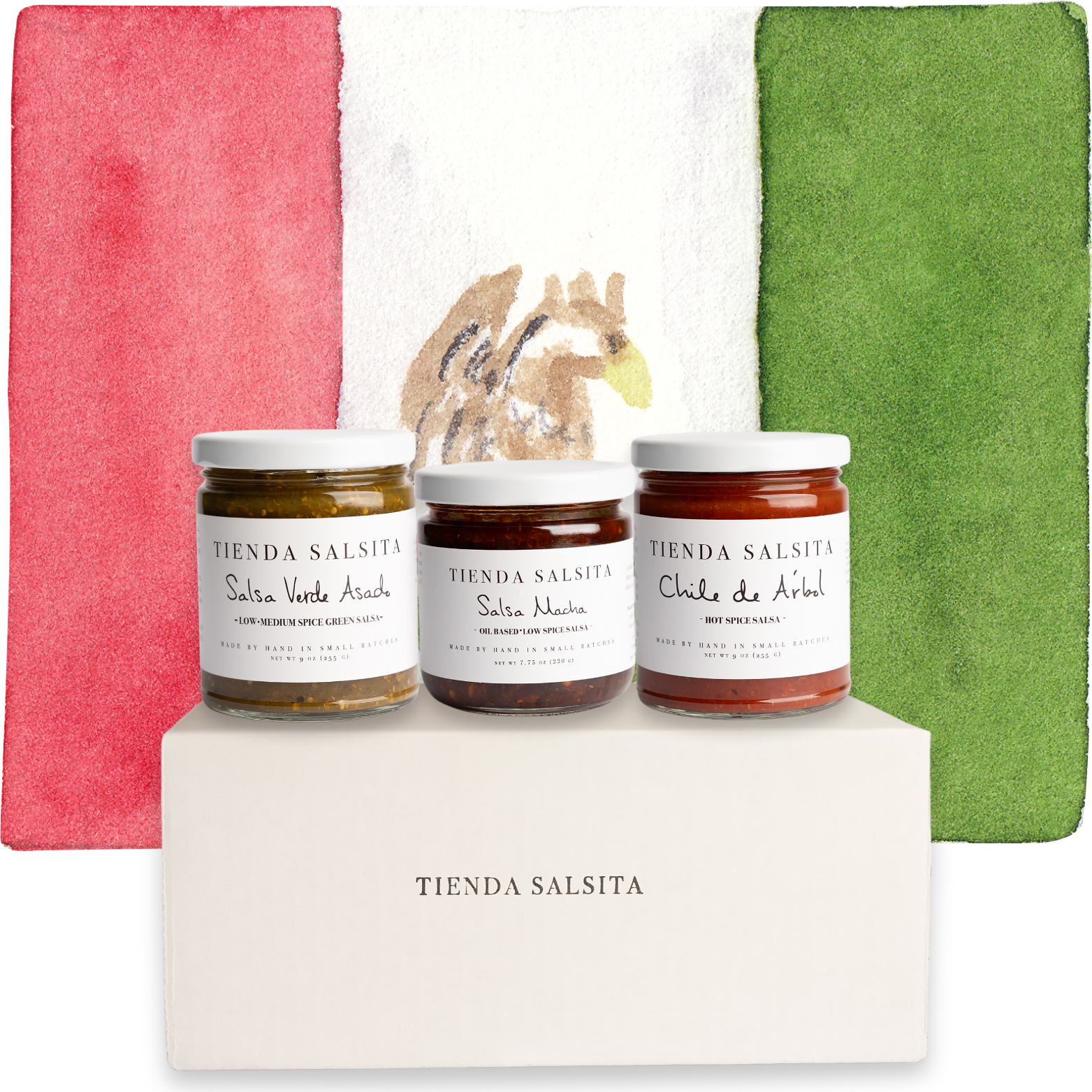Three jars of Tienda Salsita salsa on a white platform with a Mexican flag in the background.