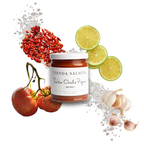Jar of Tienda Salsita salsa with chili peppers, tomatoes, and limes on a white background